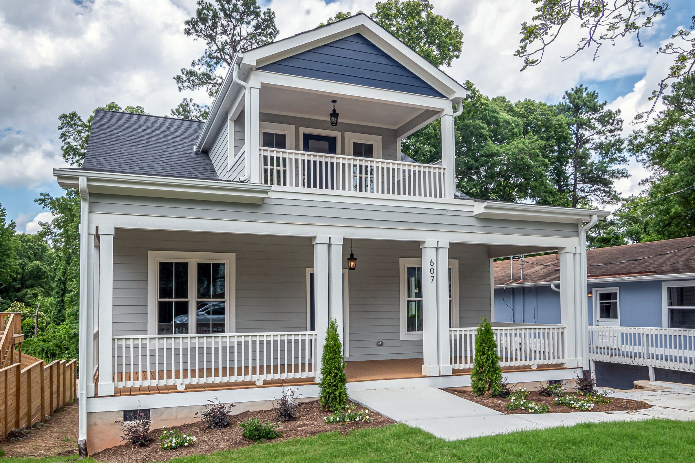 Two-story white house with a covered front porch and balcony